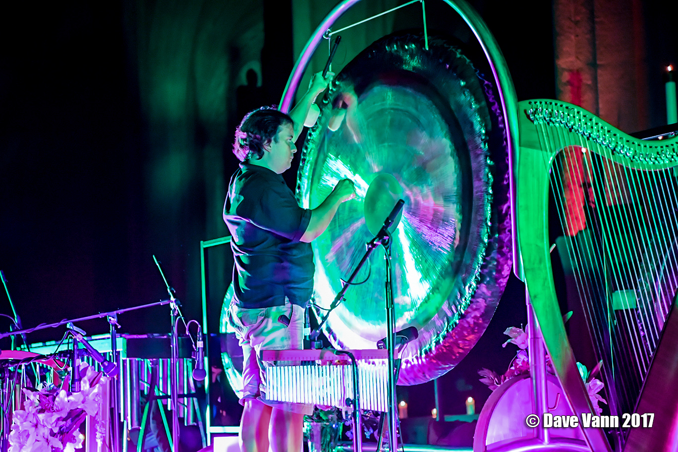 Musician playing a large gong during a sound bath performance