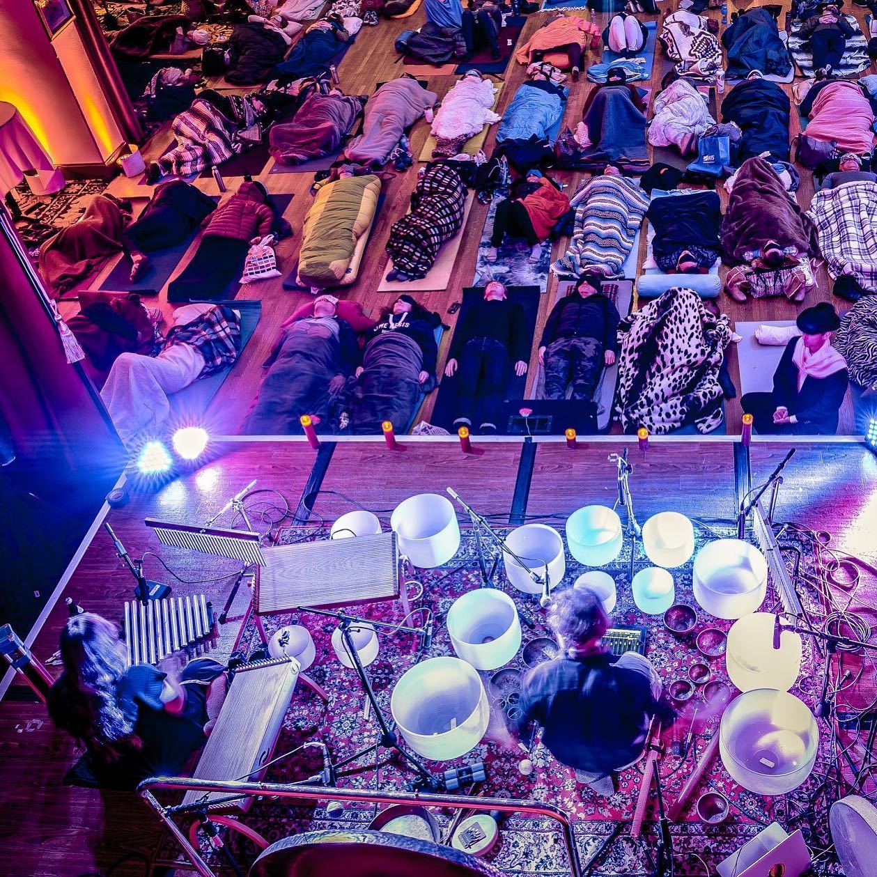 Overhead view of a sound bath event with crystal bowls
